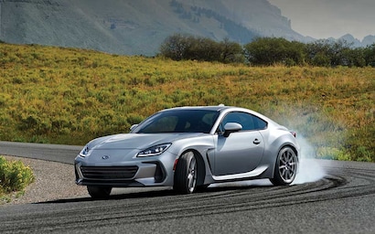 2022 Subaru BRZ Limited shown in Ice Silver Metallic rounding a curve on a highway. 
