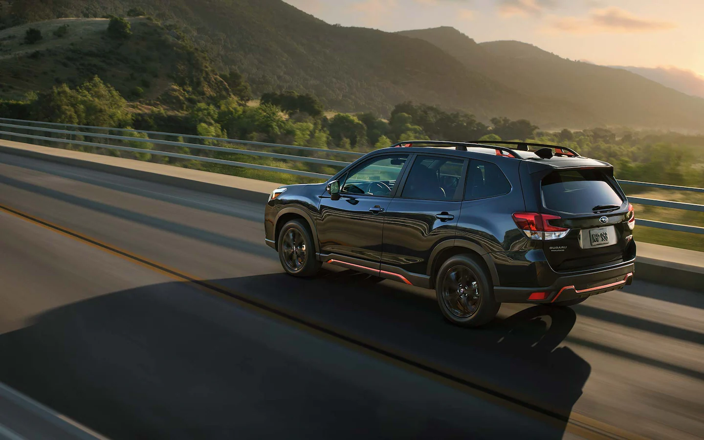 A 2022 Forester Sport driving on a country highway.